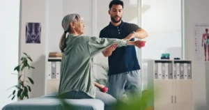 Physical therapist helping patient with exercises at home in Rockwall TX