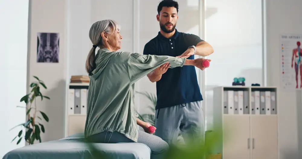 Physical therapist helping patient with exercises at home in Rockwall TX